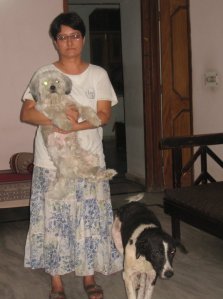 Urvashi with Standlie-the Lhasa apso (in her arms) and Minni- the blind street dog (by her side)